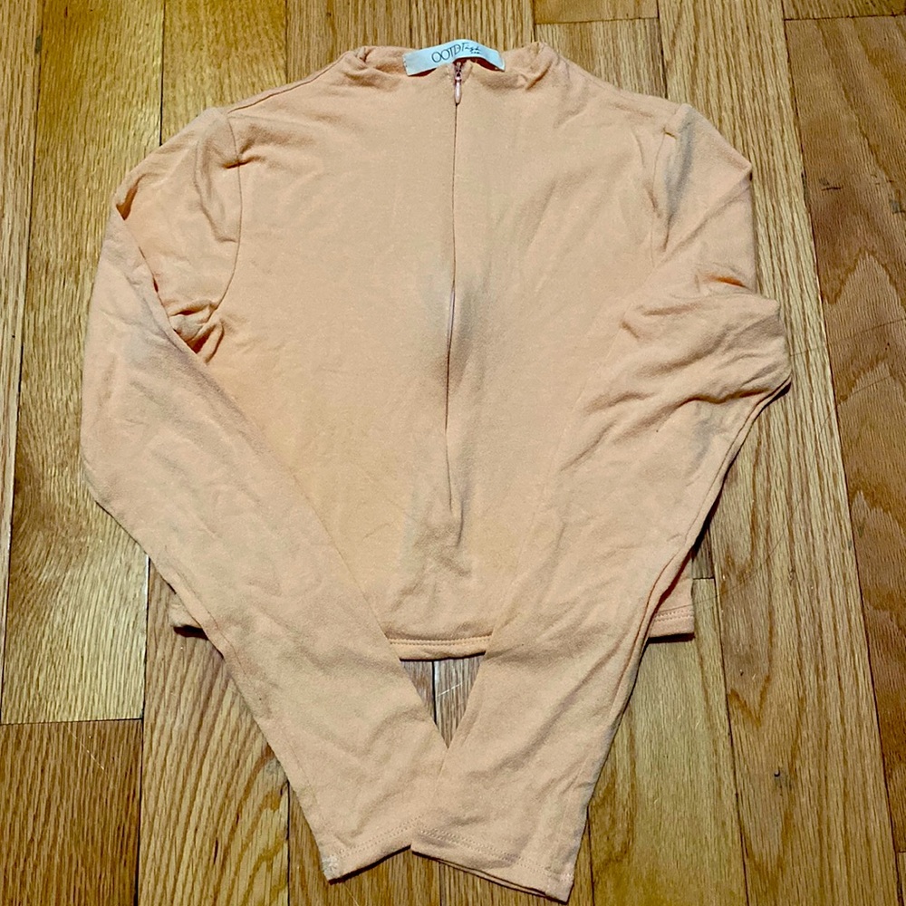 COPY - A cropped long sleeve shirt.